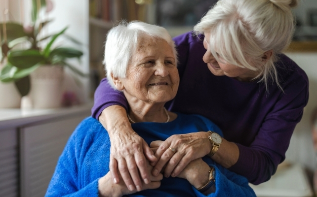 elderly person being embraced 