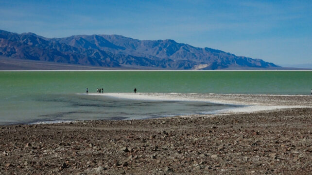 A wide view of a lake with mountains in the background