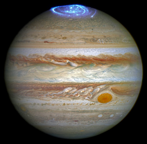 This image combines an image taken with the NASA/ESA Hubble Space Telescope in the optical and observations of the Jovian aurora in the ultraviolet. Image credit: NASA / ESA.
