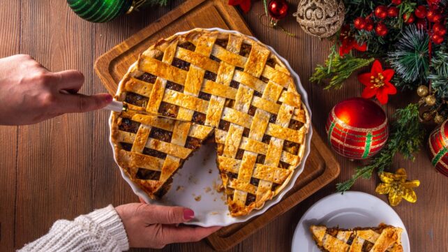 A Christmas pie with a slice removed.