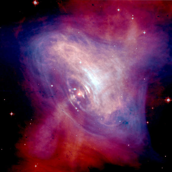 This composite image shows the Crab Nebula. The Crab pulsar is in the center of the image. Image credit: X-ray - NASA / CXC / ASU / J. Hester et al.; optical - NASA / HST / ASU / J. Hester et al.