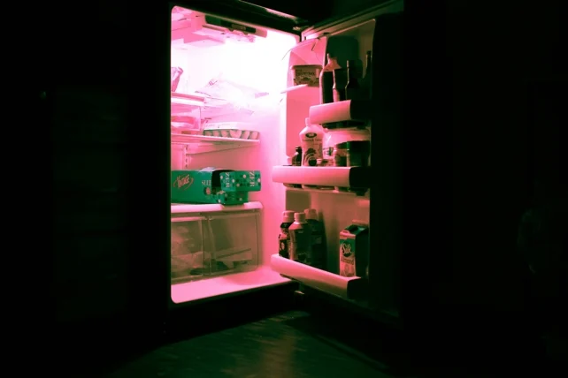 An open refrigerator filled with various food items.